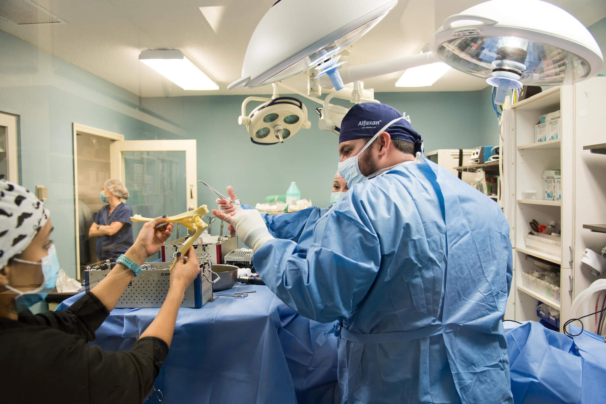 A team of surgeons work together in surgical suite.