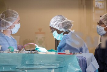 Three surgeons prepare for operation.