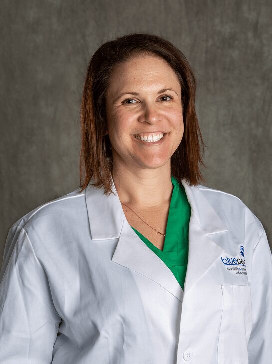 Dr. Lenore Bacek smiling in BluePearl white coat.