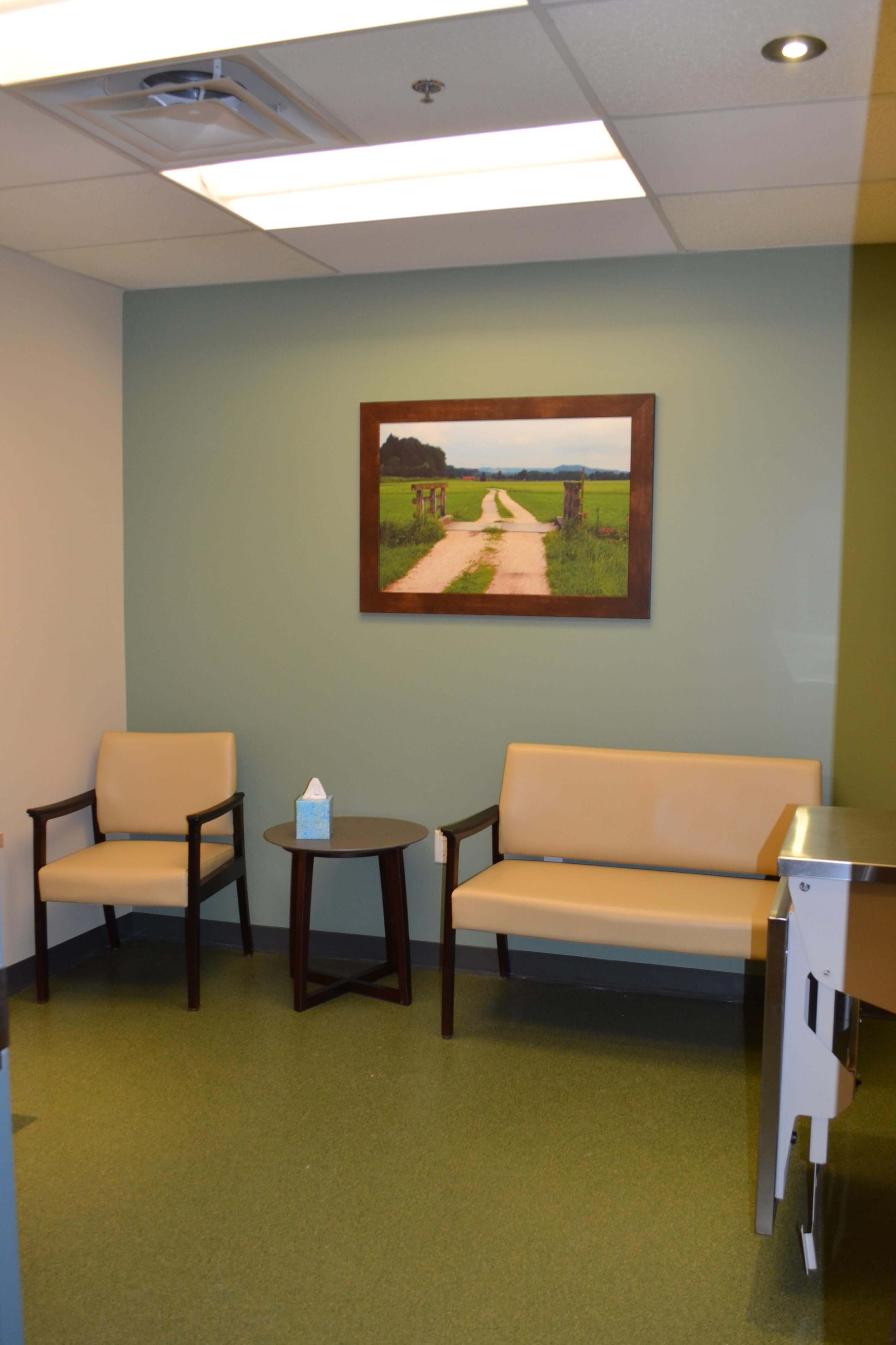 A bench, small table, and chair are in the compassion room.