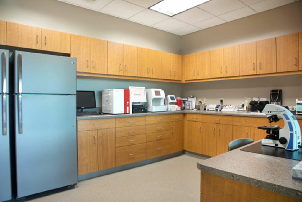 Hospital kitchen has refrigerator and counter space.