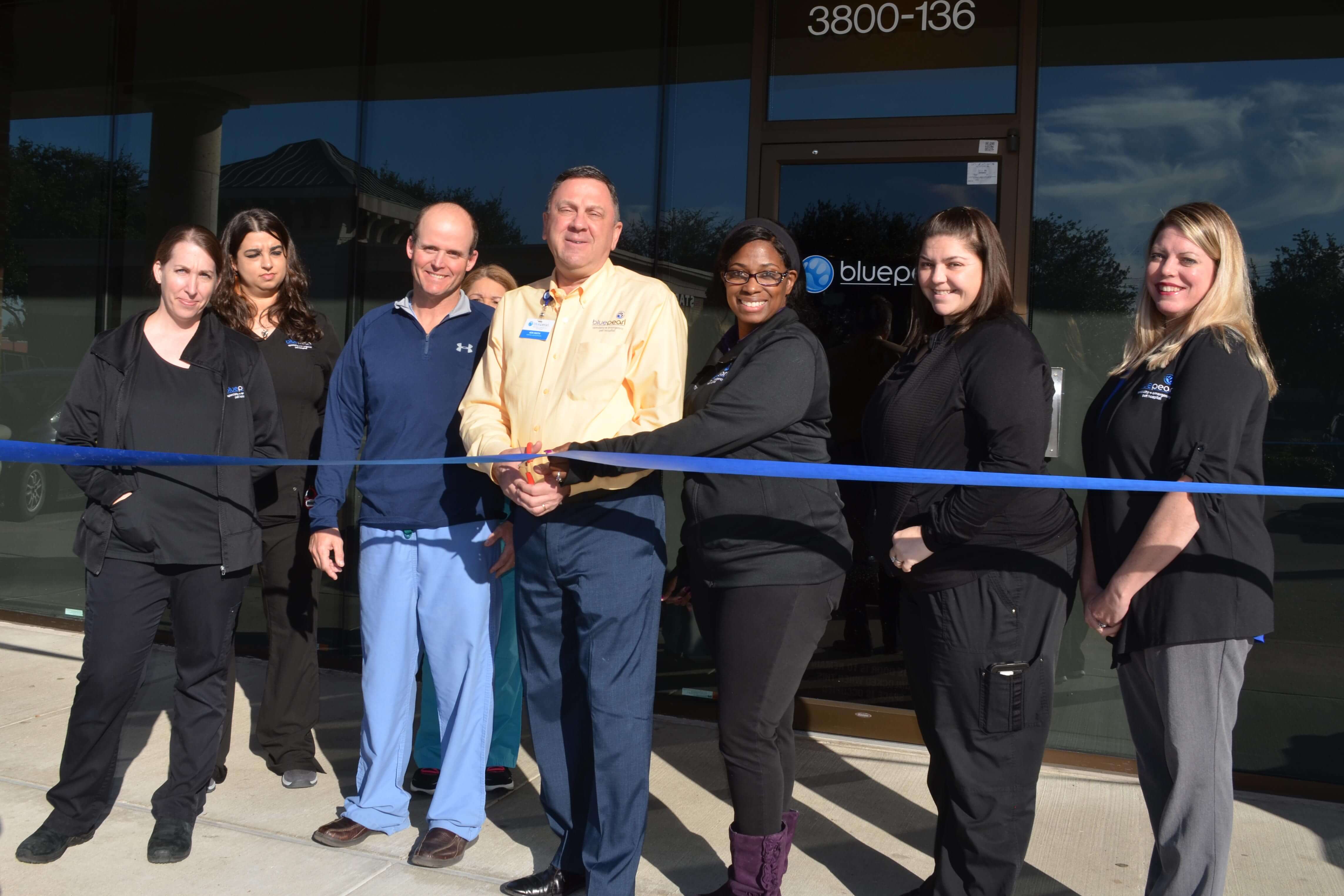 A hospital team cuts a ribbon signifying the opening of a new hospital location in Greenway, TX.