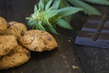 Cookies, marijuana buds and chocolate are on a table.