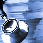 stethoscope over a stack of files