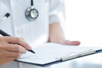 A clinician holds a checklist