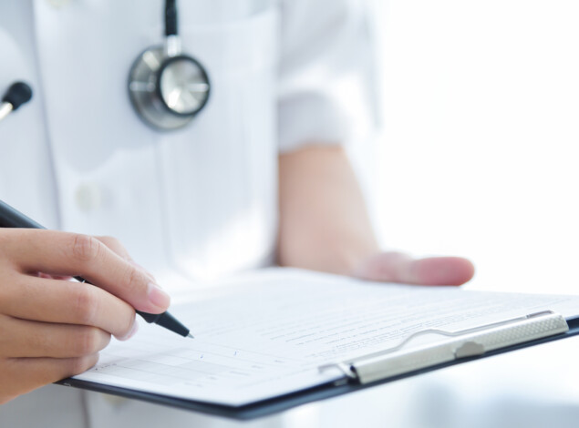 A clinician holds a checklist