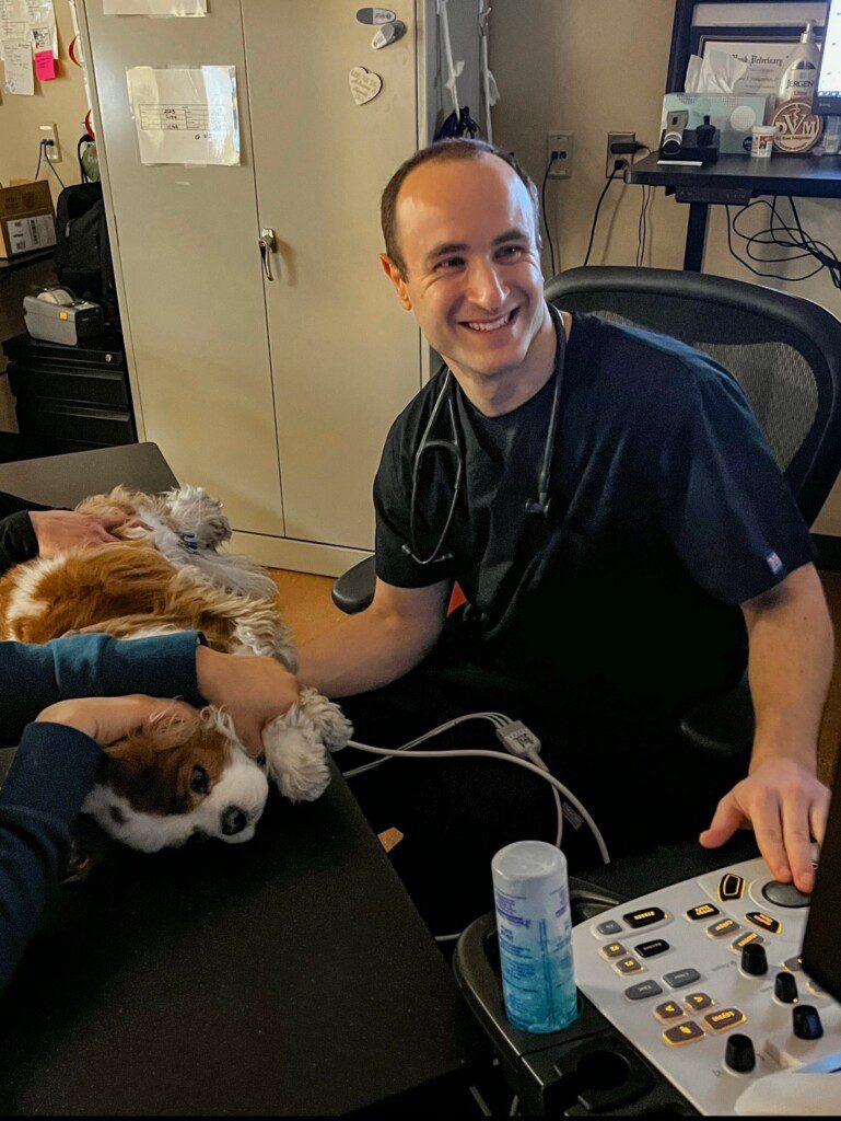 Dr. Feldgerber smiles while examining a patient.