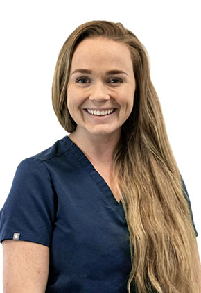 Dr. Caitlin Cowan smiles for a professional headshot. She is wearing navy BluePearl scrubs that feature her name and specialty (Oncology).