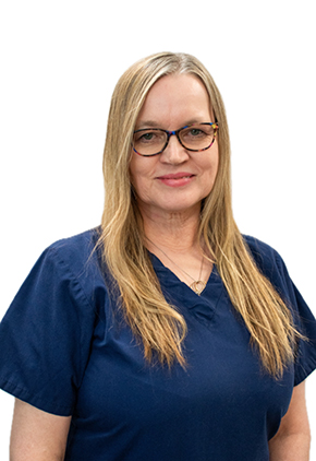Dr. Fiona Inglis smiles for a professional headshot in front of a white background. She is wearing navy blue scrubs.