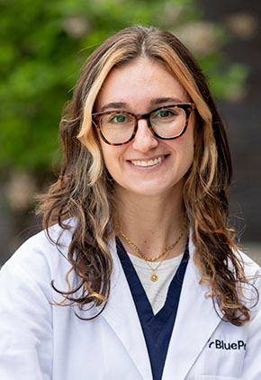 Dr. Rachel Crawford outside smiling in her white coat.