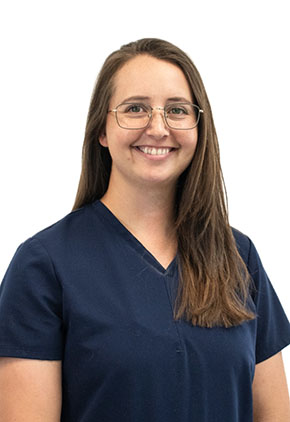 Dr. Kylie White smiles for a professional headshot. She is wearing navy BluePearl scrubs that feature her name and specialty (Emergency Medicine).