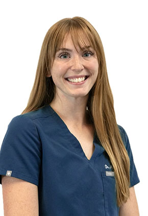 Dr. Abigail Turner smiles for a professional headshot. She is wearing navy BluePearl scrubs that feature her name and specialty (Emergency Medicine).