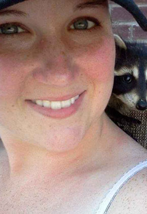Moriah Partney smiles outside with a ferret on her shoulder.