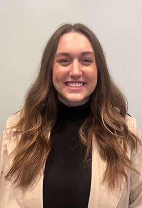 Dr. Jessica Hayes smiles for a professional headshot. She is wearing a black turtleneck and khaki jacket.