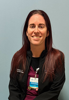 Melanie Doyle smiles for a headshot. She is wearing a black BluePearl jacket.