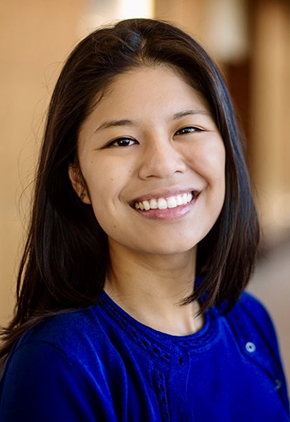 Dr. Grace Zhang smiles for a professional headshot. She is wearing a blue sweater.