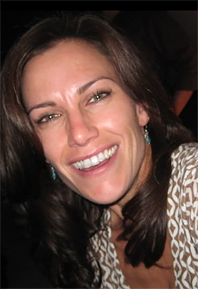 Dr. Josie Speights smiles for a photo. She is wearing a tan and white dress shirt.
