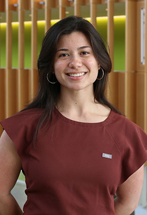 Dr. Ashley Broderick smiles for a professional headshot. She is wearing a maroon top.