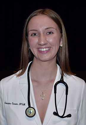 Dr. Christine Cassen smiles for a headshot. She is wearing her whitecoat and has a stethoscope around her neck.
