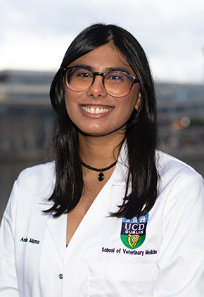 Dr. Anaida Mama smiles outside in her University College Dublin whitecoat.