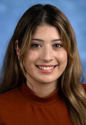 Dr. Stephanie Fonseca smiles for a professional studio headshot. She is wearing a dark red blouse.